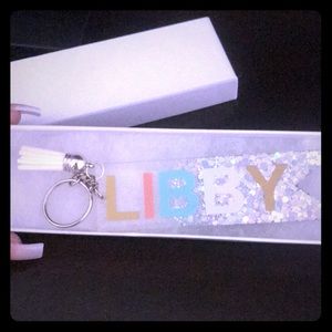 Monogrammed key chain says Libby with tassel.